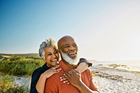 elderly biracial couple smiling in sun